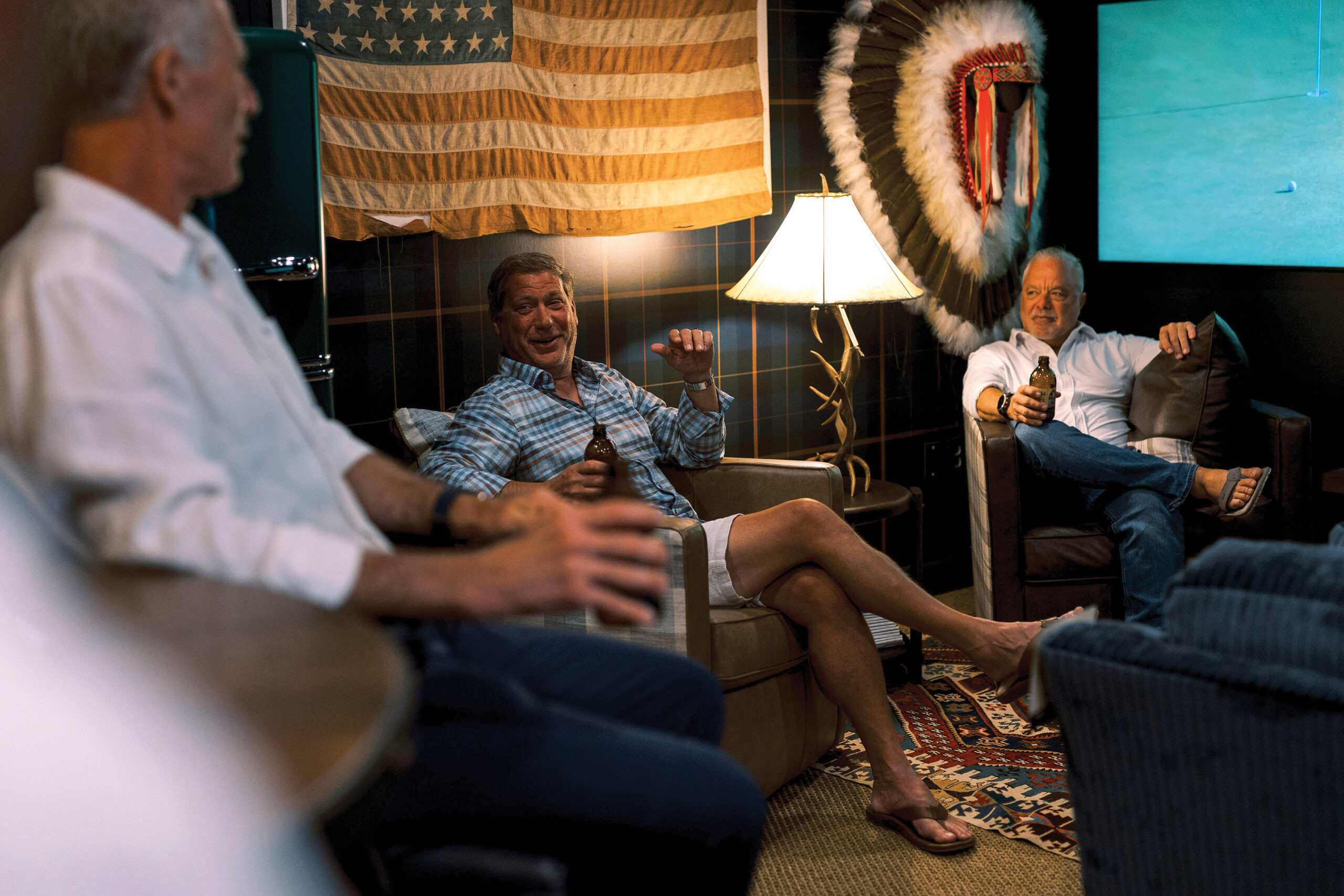 Laughing Men Seated Under American Flag