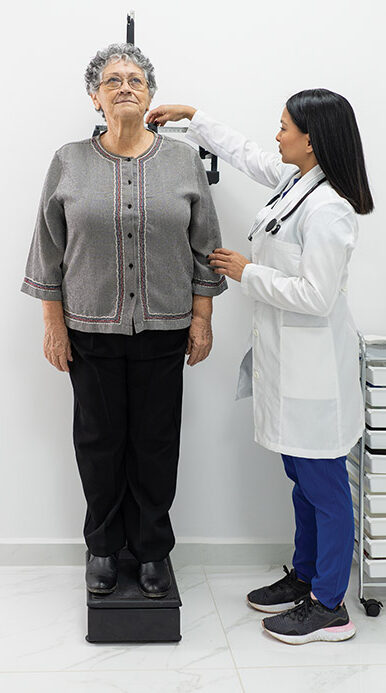 Doctor measuring patient's height