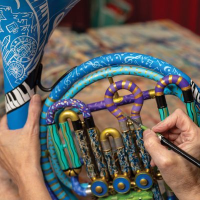Artist painting musical instrument