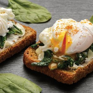 Healthy breakfast - sandwich with cheese, spinach and poached egg.