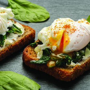 Healthy breakfast - sandwich with cheese, spinach and poached egg.