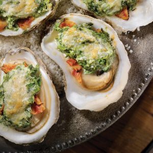 Oysters Rockefeller, baked oysters in a cream sauce with spinach, Swiss cheese and topped with bread crumbs