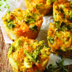 Healthy snack Broccoli muffins with cheddar cheese and thyme close-up on the table. Vertical